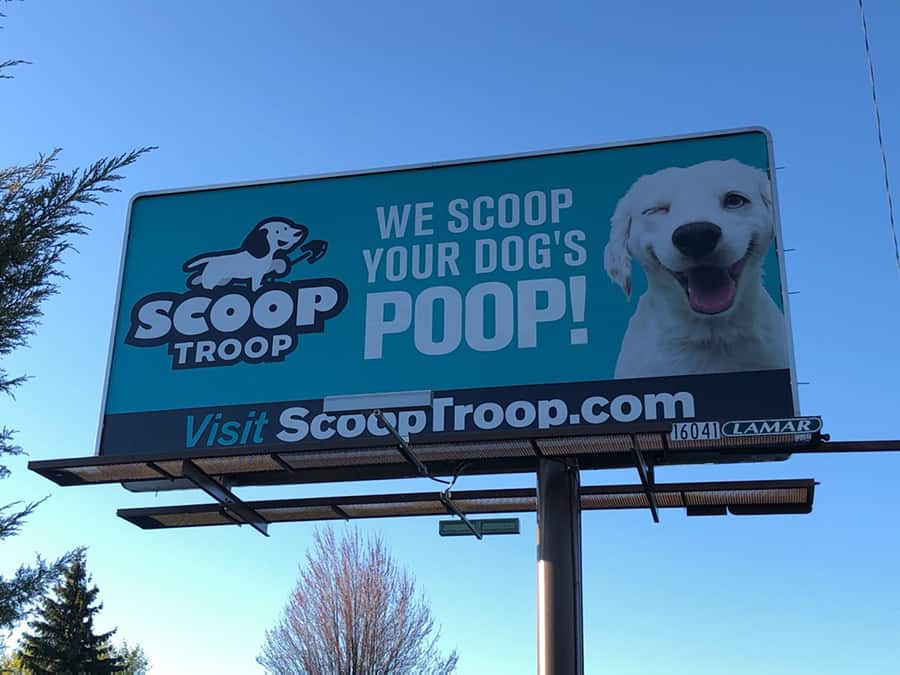 Scoop Troop billboard located in Spokane WA. "We scoop your dog's Poop!"